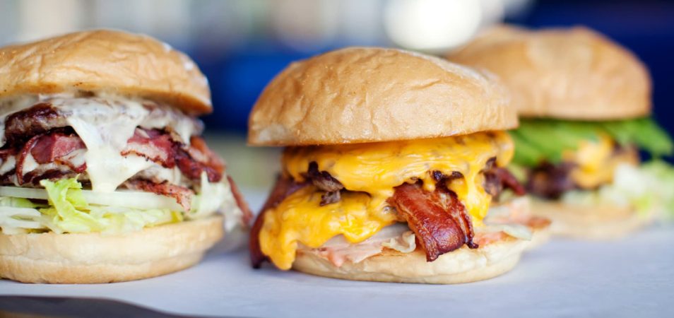 Three burger sliders with cheese, bacon, and other toppings at Mel's Hard Luck Diner, a Branson, Missouri, restaurant.