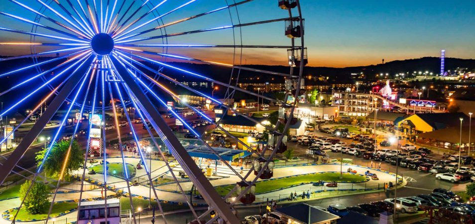 A ferris wheel with the city of Branson, Missouri lit up in the distance.