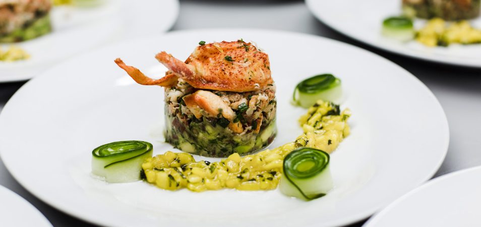 A vegetable lobster risotto food plate at a restaurant in Little Italy in California.