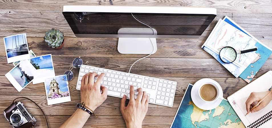 Man at computer keyboard explores new Club Wyndham website experiences.