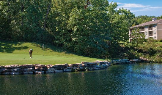 A man plays on a waterfront golf course at WorldMark Branson, a timeshare resort in Branson, Missouri. 