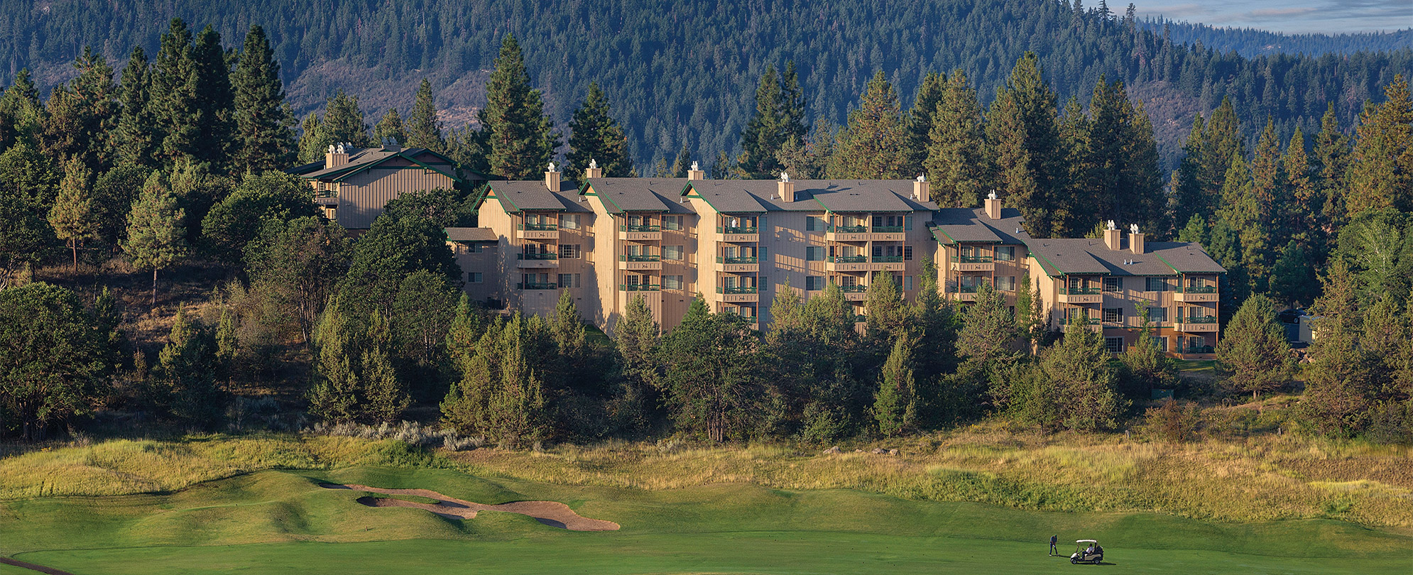 Tall trees surrounding a large resort with a golf course in Oregon at the Worldmark Running Y.