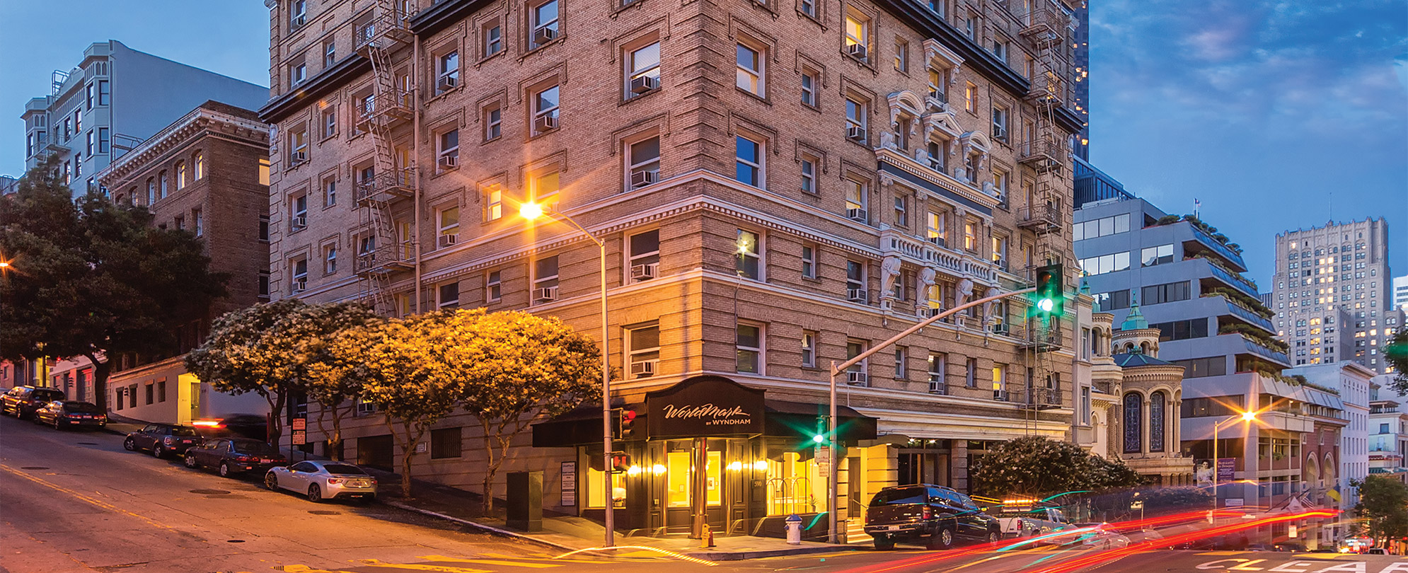 The outside of WorldMark San Francisco resort lit up at night.