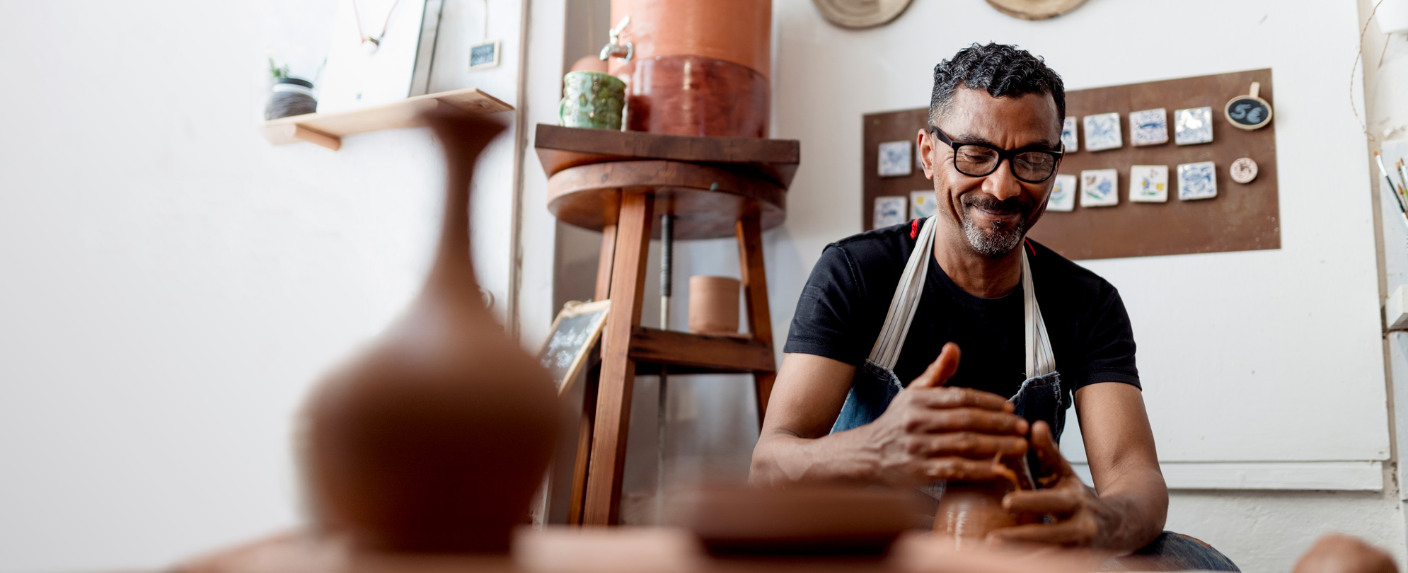 A ceramist working with a pottery wheel